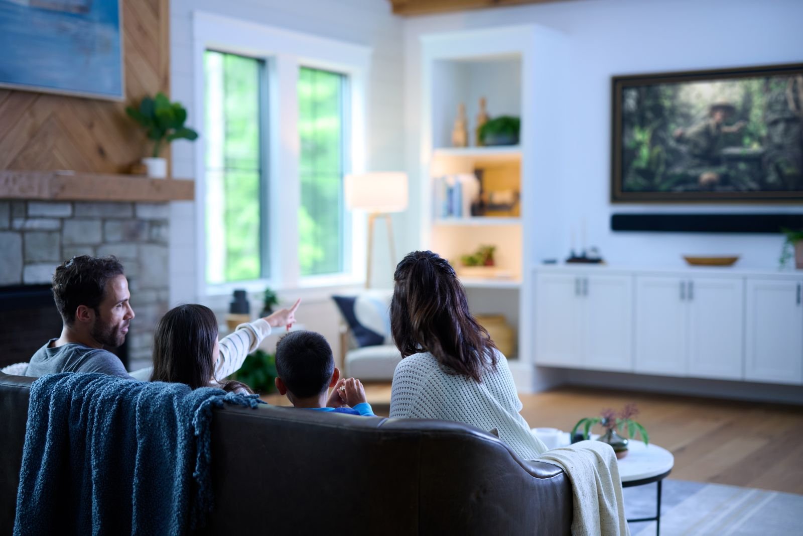 Family watching a film together in a Savant-controlled living room